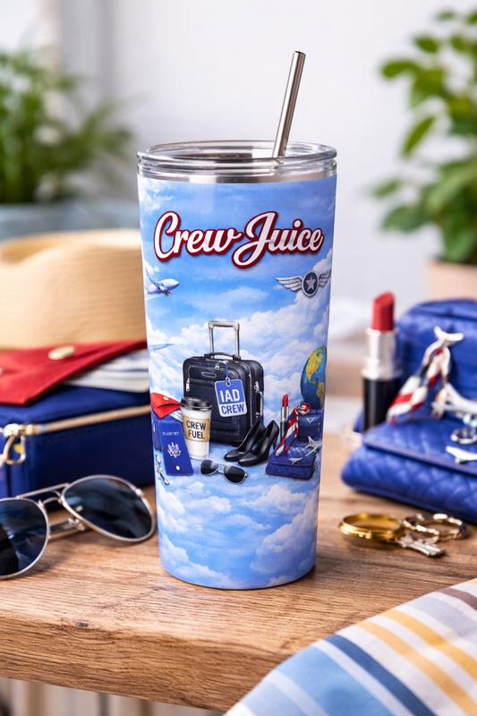 Tumbler with 'Crew Juice' design on a table with travel-themed items